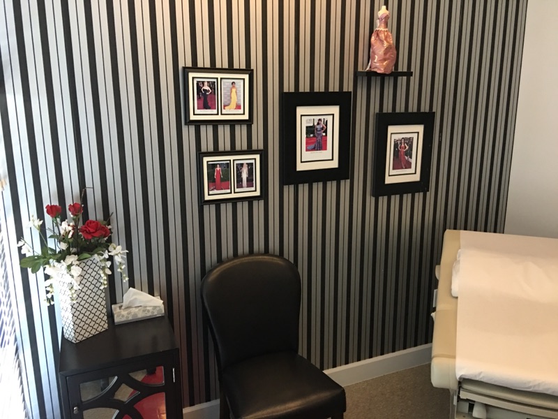 MomDoc Chandler OB-GYN exam room with striped wallpaper and framed gown photography