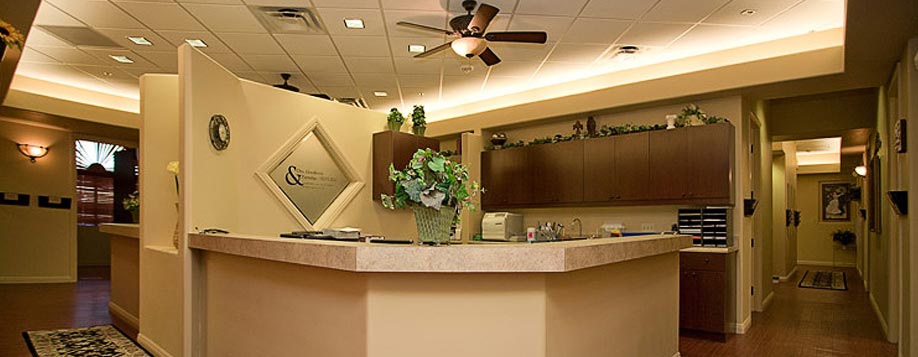 MomDoc Women for Women Maricopa OB-GYN reception desk with curved counter and plants